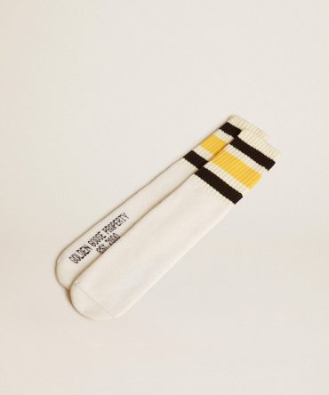 Worn-white socks with distressed details and black and yellow stripes
