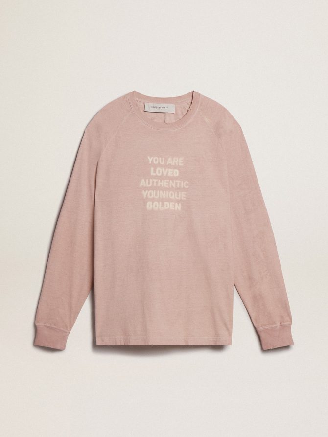 Powder-pink T-shirt with white lettering on the front