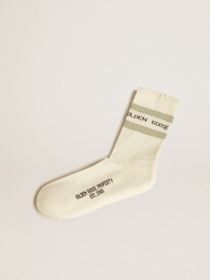 Worn-white socks with distressed details and sage-green stripes