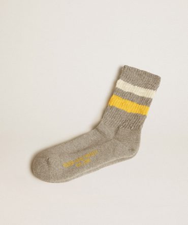Gray socks with distressed details and yellow and white stripes