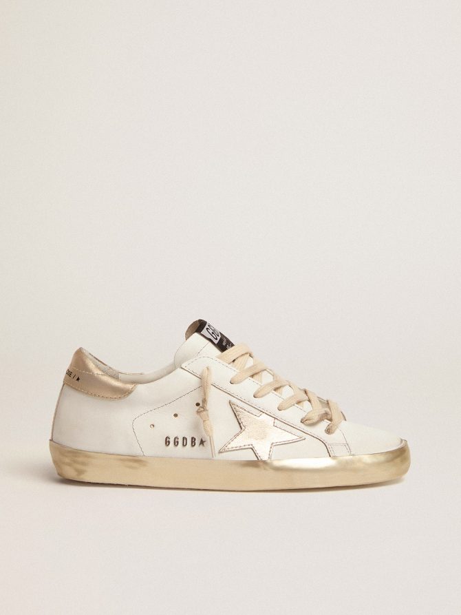 Women’s Super-Star with gold sparkle foxing and metal stud lettering